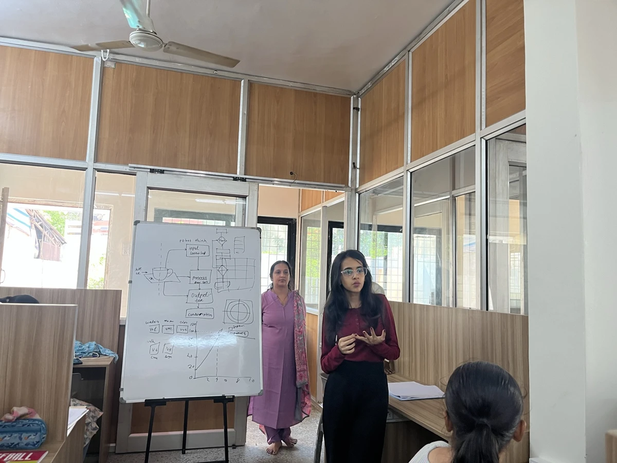 A student explaining work at the presentation board